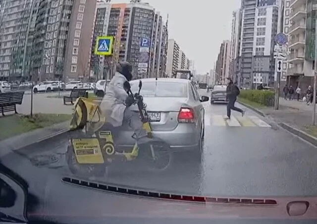  В Мурине доставщик еды на самокате врезался в стоящий авто и скрылся